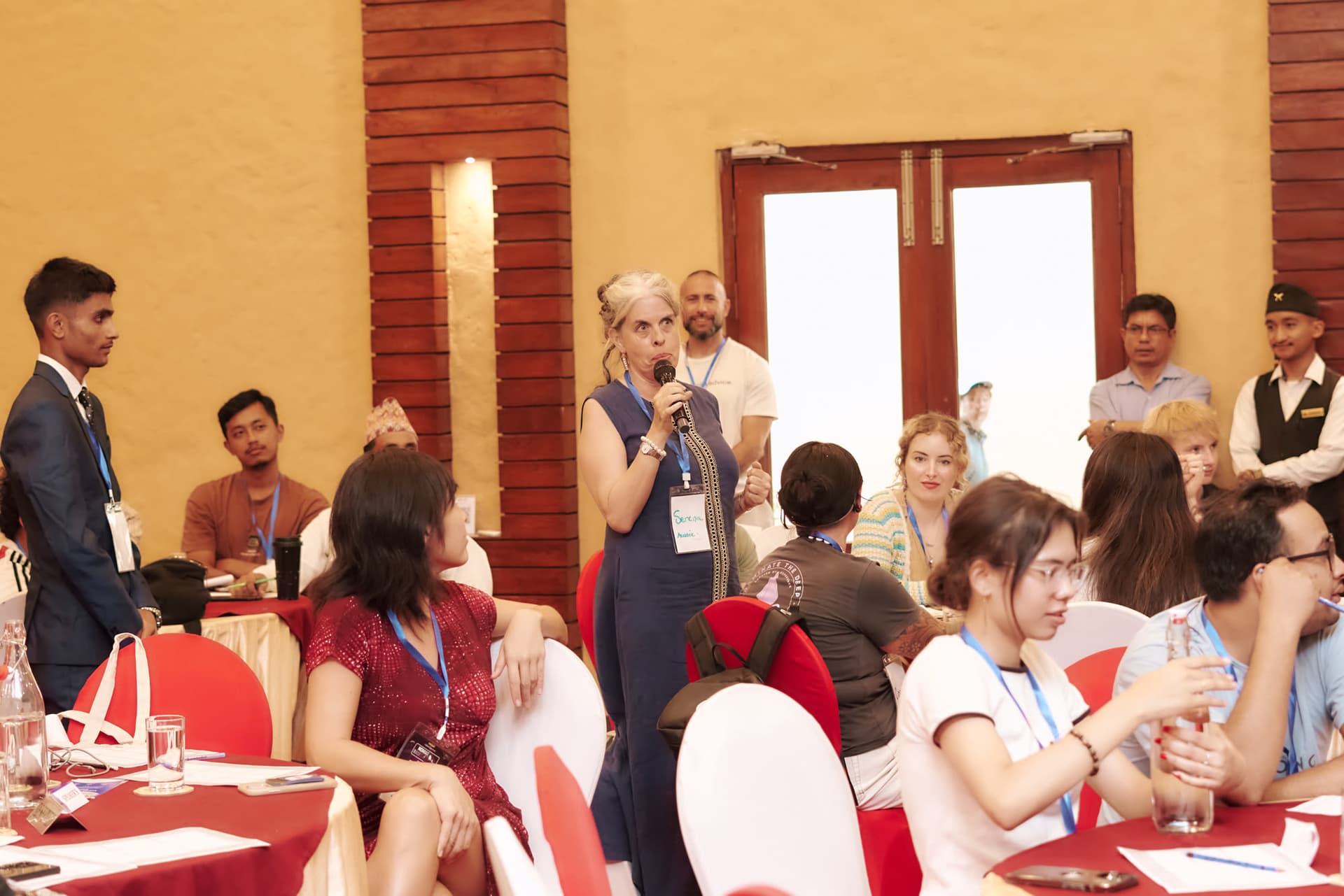 An attendee asking a question during a Q&A session