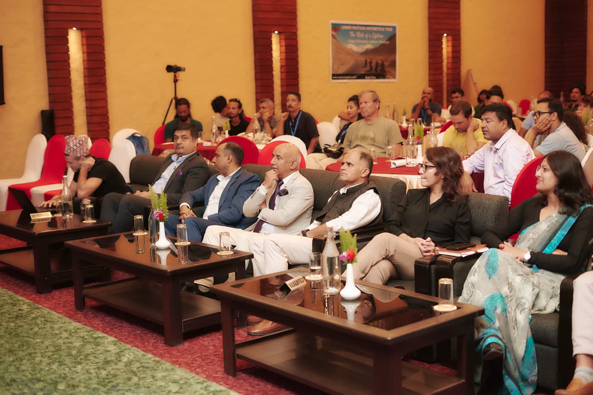 Guests seated in the front row during a panel discussion