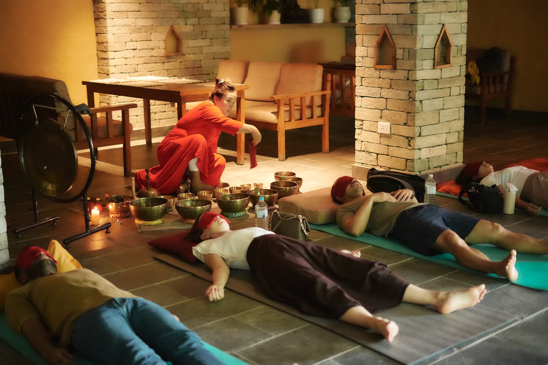 Attendees lying on mats during a singing-bowl sound bath session